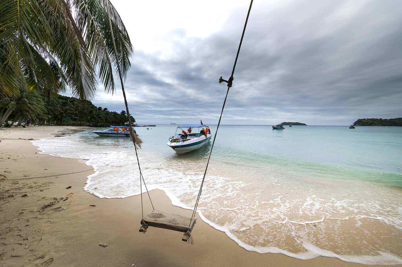 Swing on beach near palm tree - How to hang a swing from a tree without branches