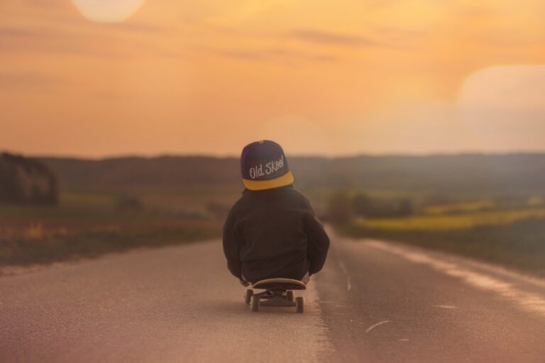 Young boy sitting on skateboard - Best skateboard for 5-year-old kids