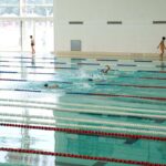 Kids practicing in Olympic-sized indoor pool - Best swimming camp for kids in the United States