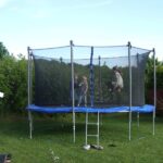 Three kids on round trampoline with safety enclosure - The 5 Best Trampolines for Kids