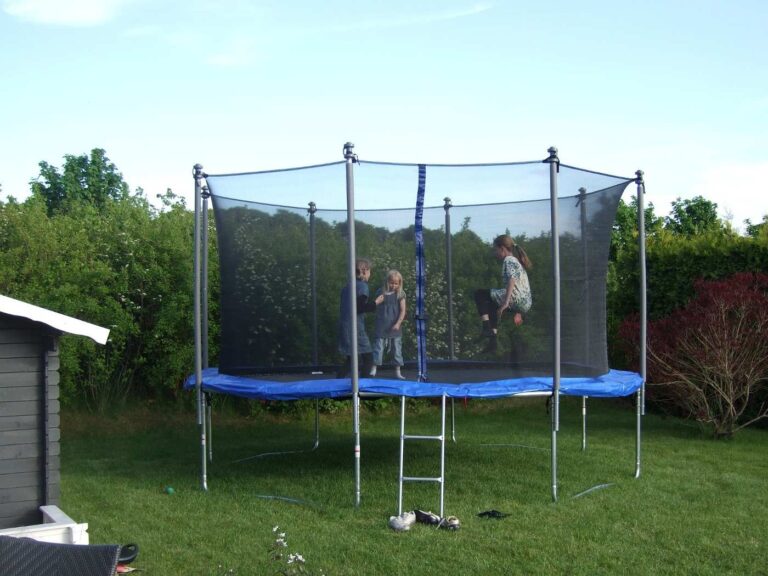 Three kids on round trampoline with safety enclosure - The 5 Best Trampolines for Kids