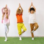 Three young children doing Yoga (tree pose) - Sports for Toddlers: Which Sport Is Best for Your Child?