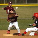 Three youths playing baseball, one catching the ball - The Best 11 Inch Baseball Gloves: Review and Buying Guide