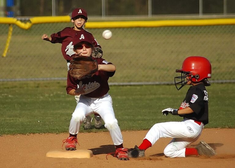 Three youths playing baseball, one catching the ball - The Best 11 Inch Baseball Gloves: Review and Buying Guide